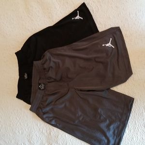 Two pair size M boys air jordan basketball shorts, one black, one gray
